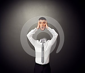 Businessman holding his amazed head in hands