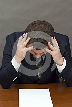 Businessman holding his head