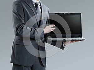 Businessman holding his laptop