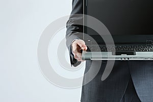 Businessman holding his laptop