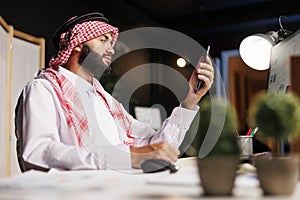 Businessman holding his smartphone