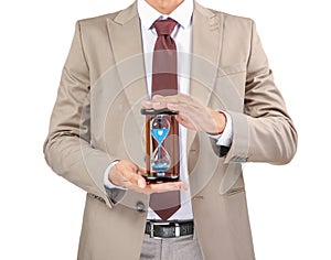 Businessman holding hourglass on white background. Time management concept