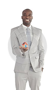 Businessman holding a house in his hands