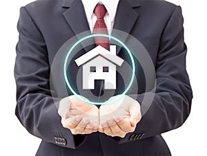 Businessman holding house icon