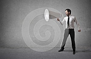 Businessman holding a huge megaphone