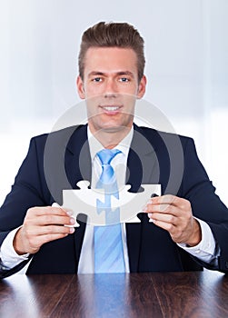 Businessman Holding Jigsaw Puzzle