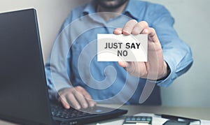 Businessman holding Just Say No text on business card