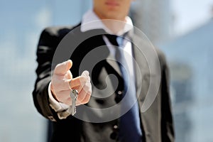 Businessman holding a key in his hand