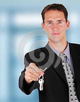 Businessman holding key in his hand to hand it over