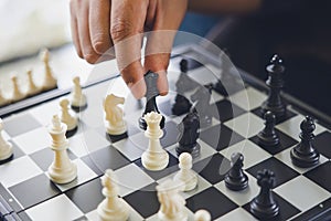 Businessman holding a King Chess is placed on a chessboard.using as background business concept and Strategy concept with copy