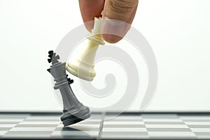 Businessman holding a King Chess is placed on a chessboard.using as background business concept and Strategy concept with copy sp