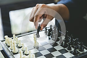 Businessman holding a King Chess is placed on a chessboard.using as background business concept and Strategy concept with copy