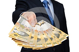 Businessman holding Korean currency in hand on white background