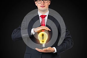 Businessman holding lamp