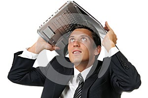 Businessman holding a laptop above his head