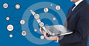 Businessman holding laptop with connecting icons