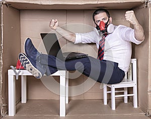 Businessman holding laptop on lap, hands up gesture of success in business