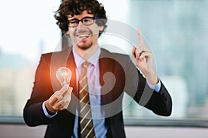 Businessman holding light bulb. Brain creative thinking ideas and innovation concept