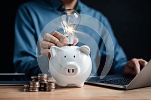 Businessman holding light bulb on piggy bank icon. saving money idea strategy and financial, investment, bank, finance, financial