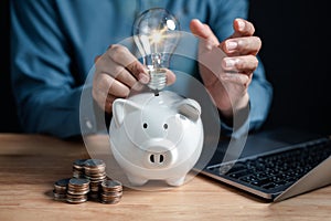 Businessman holding light bulb on piggy bank icon. saving money idea strategy and financial, investment, bank, finance, financial