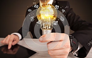 Businessman holding a light bulb, social media concept