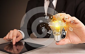 Businessman holding a light bulb, social media concept