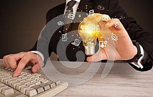 Businessman holding a light bulb, social media concept