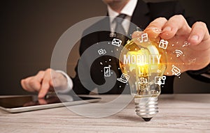 Businessman holding a light bulb, social media concept