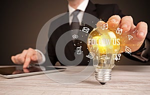 Businessman holding a light bulb, social media concept