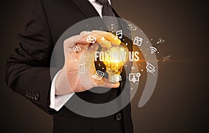 Businessman holding a light bulb, social media concept