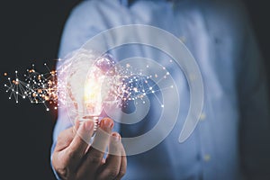 Businessman holding light bulb with virtual cloud computing download and upload database with copy space. Ideas creative