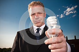 Businessman holding lightbulb