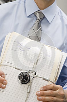 Businessman Holding Locked File Folders