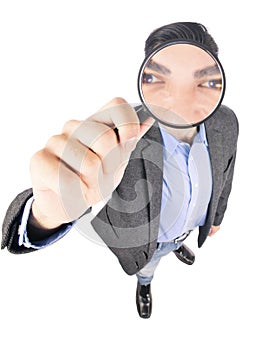 Businessman holding magnify glass