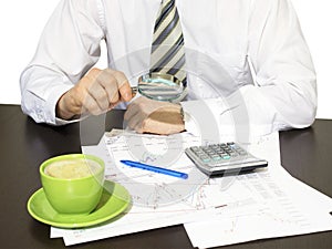 Businessman holding magnifying glass