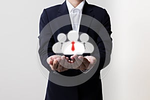 Businessman holding managers and team symbols photo