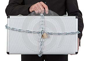 Businessman holding metal suitcase