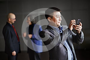 Businessman holding mobile smart phone using app