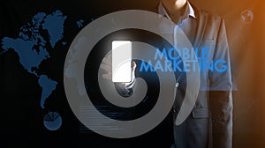 Businessman holding a mobile smartphone with white blank screen with space for text ,inscription word MOBILE MARKETING.Business,