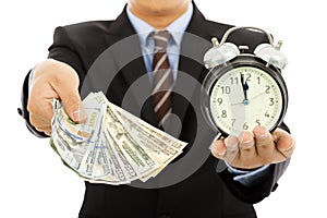 Businessman holding money and clock. time is money concept