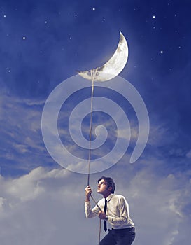 Businessman Holding the Moon