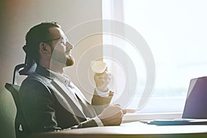 businessman holding morning cup of coffee