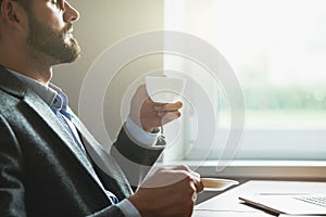 businessman holding morning cup of coffee