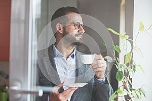 businessman holding morning cup of coffee