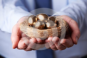 Businessman Holding Nest Full Of Golden Eggs