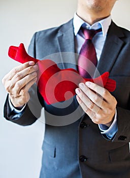 Businessman holding open armed heart with hands - warm welcome a
