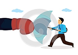 Businessman holding an open umbrella which protects from attacking boxing