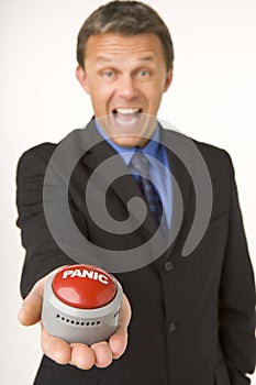 Businessman Holding A Panic Button