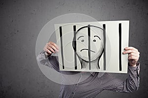 Businessman holding a paper with a prisoner behind the bars on i