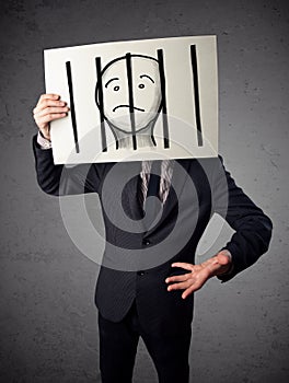 Businessman holding a paper with a prisoner behind the bars on i